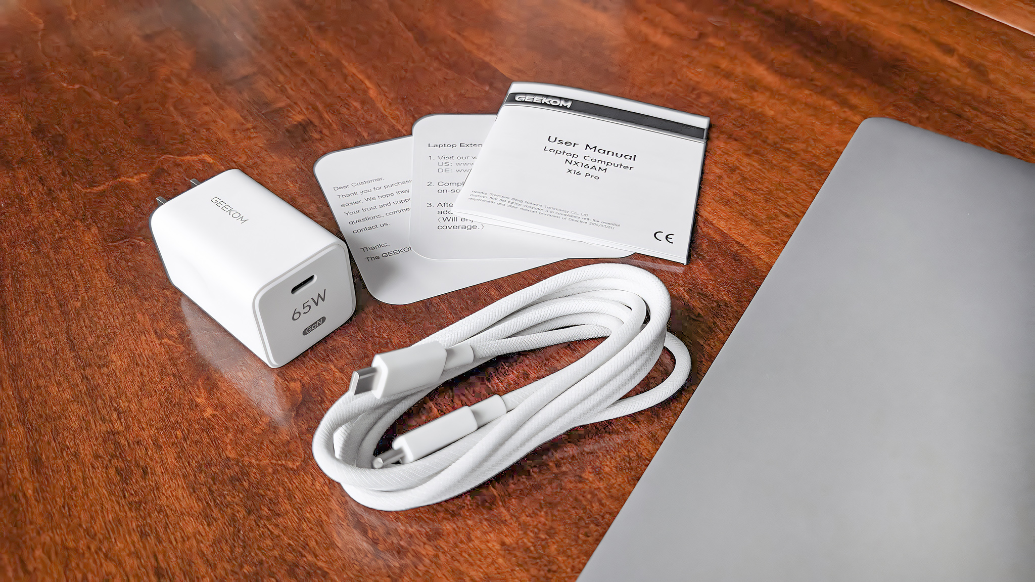 Closeup of the charging adapter and braided USB-C cable that comes with the Geekom GeekBook X16 Pro.