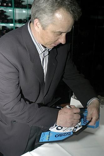 Greg LeMond signs a few autographs. LeMond's company, LeMond Fitness, will be joining as a team sponsor in 2004.