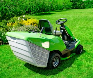 A Greenworks riding mower in a garden
