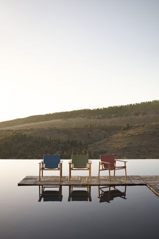 B&B Italia outdoor furniture launched in 2023, three chairs beside still water