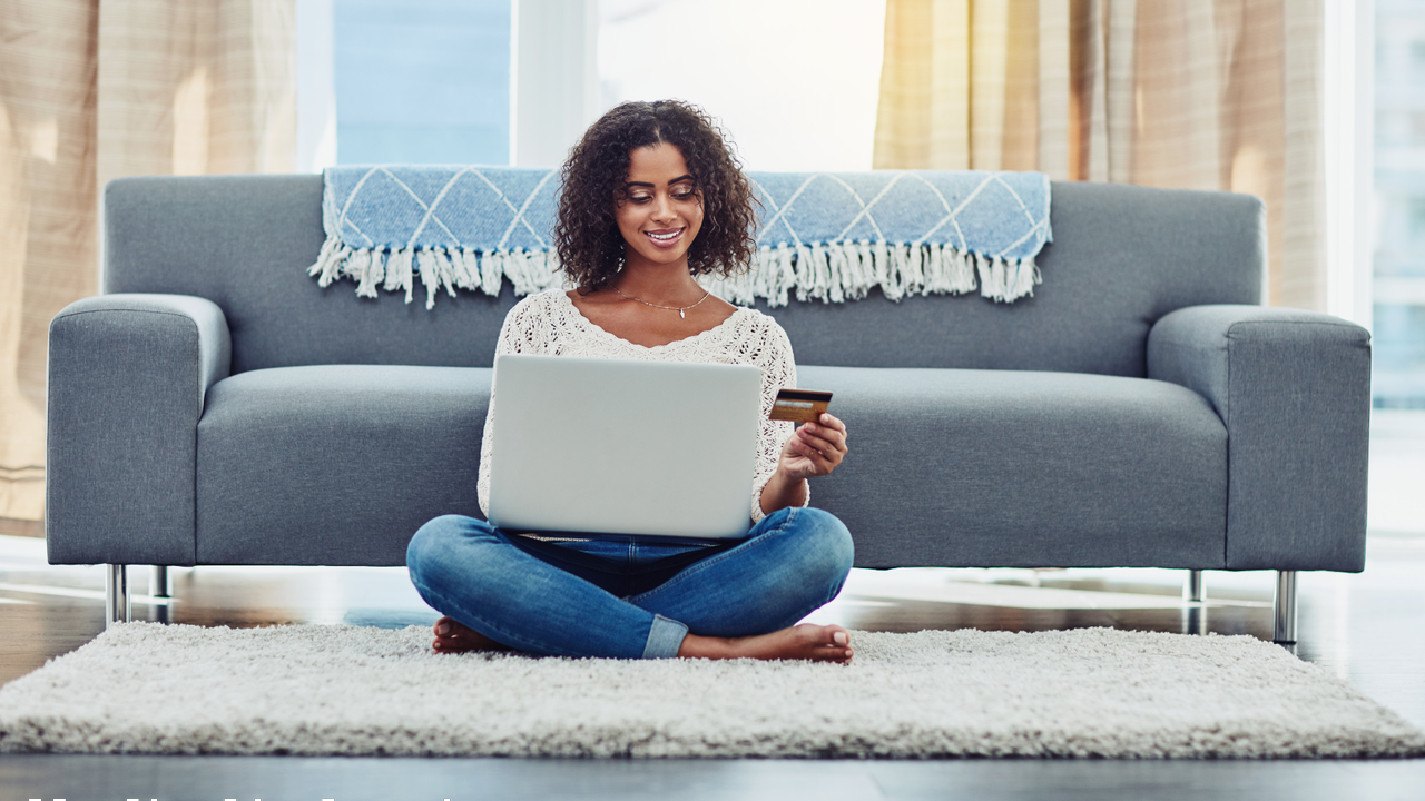 Shot of an attractive young woman making payments online with a credit card