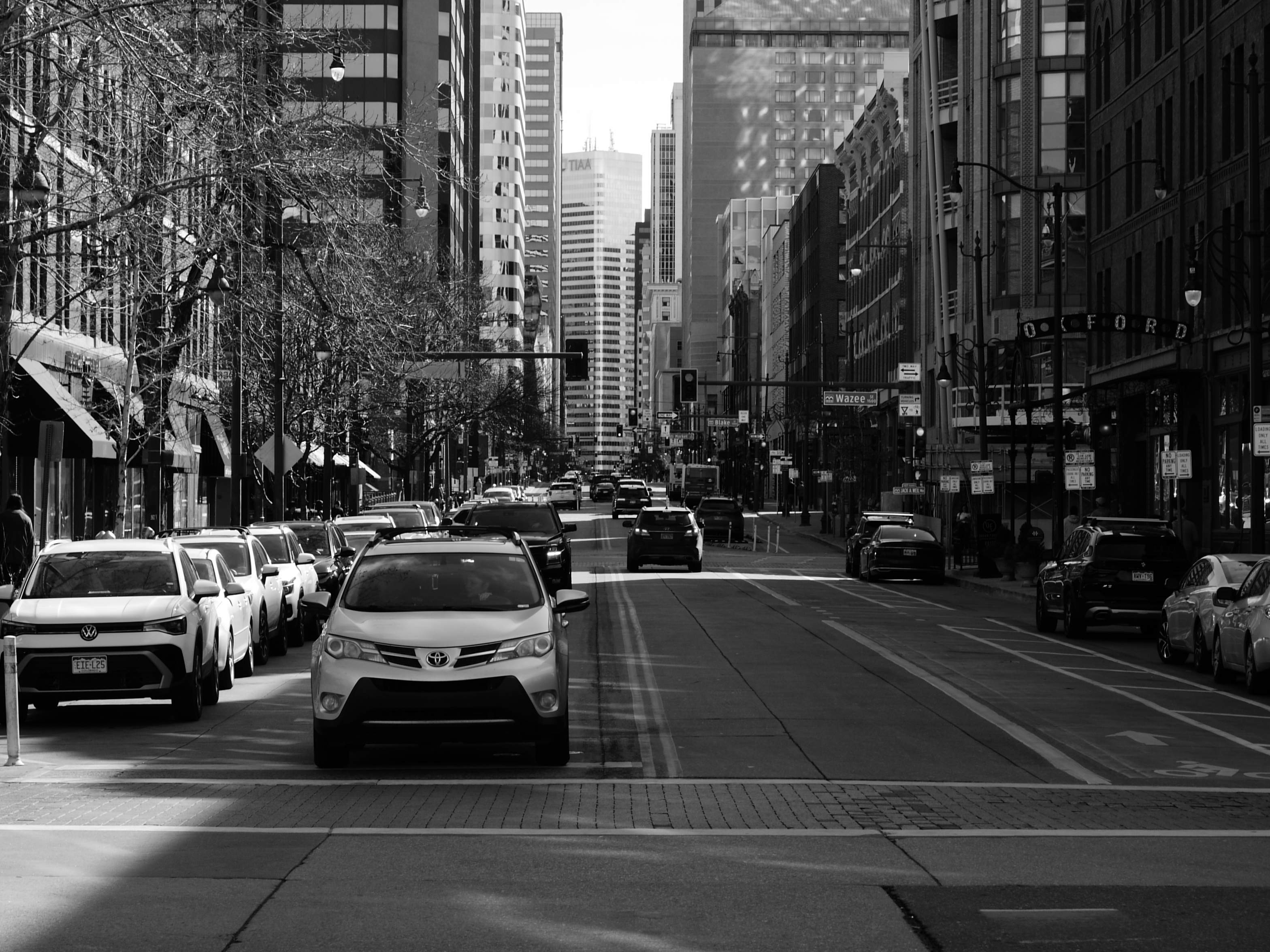 A street photo of a busy city street, shot on the Lumix L1