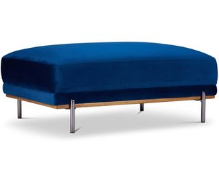 A dark blue velvet coffee table ottoman with removeable brass-colored legs