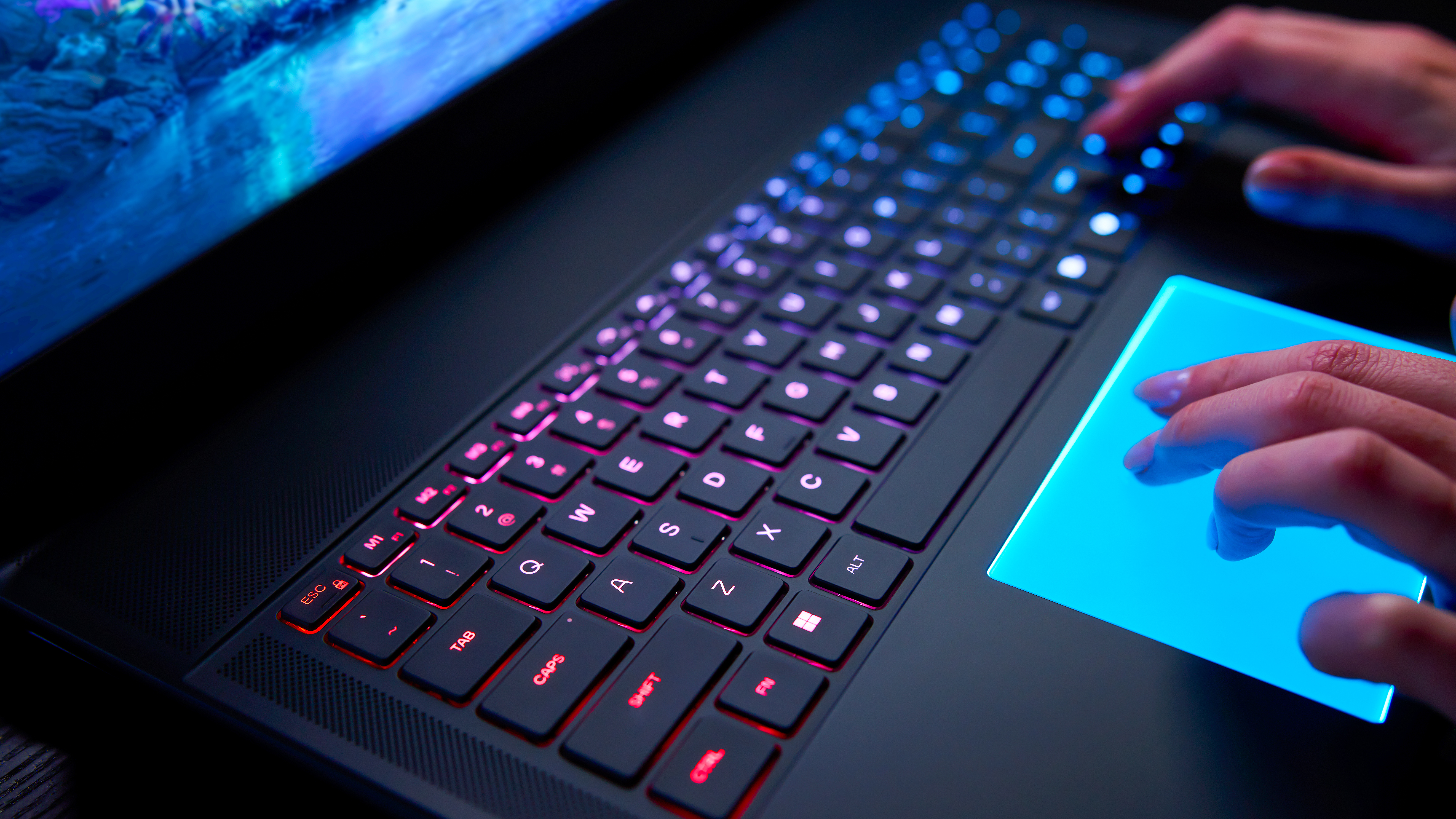 A closeup of the Alienware Area-51 laptop's backlit mechanical keyboard and RGB touchpad.