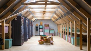 loft with boarded floor, storage boxes, belongings and hanging wardrobes