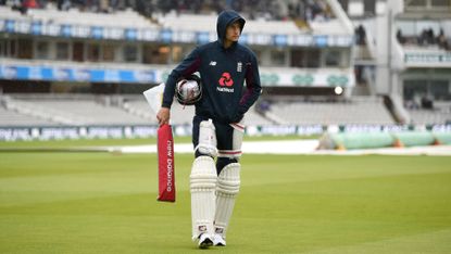 Joe Root waits for the rain to clear at Lord's