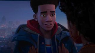 Miles stands listening to his mom on the roof in Spider Man Across the Spider-Verse.