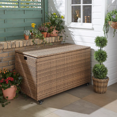 Dunelm rattan garden storage box on patio.
