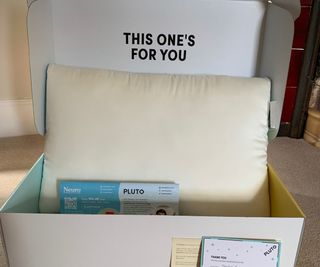 The Pluto Pillow in a delivery box.