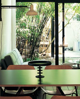 The new dining table designed by Maclean alongside a sofa by Kho Liang Le.