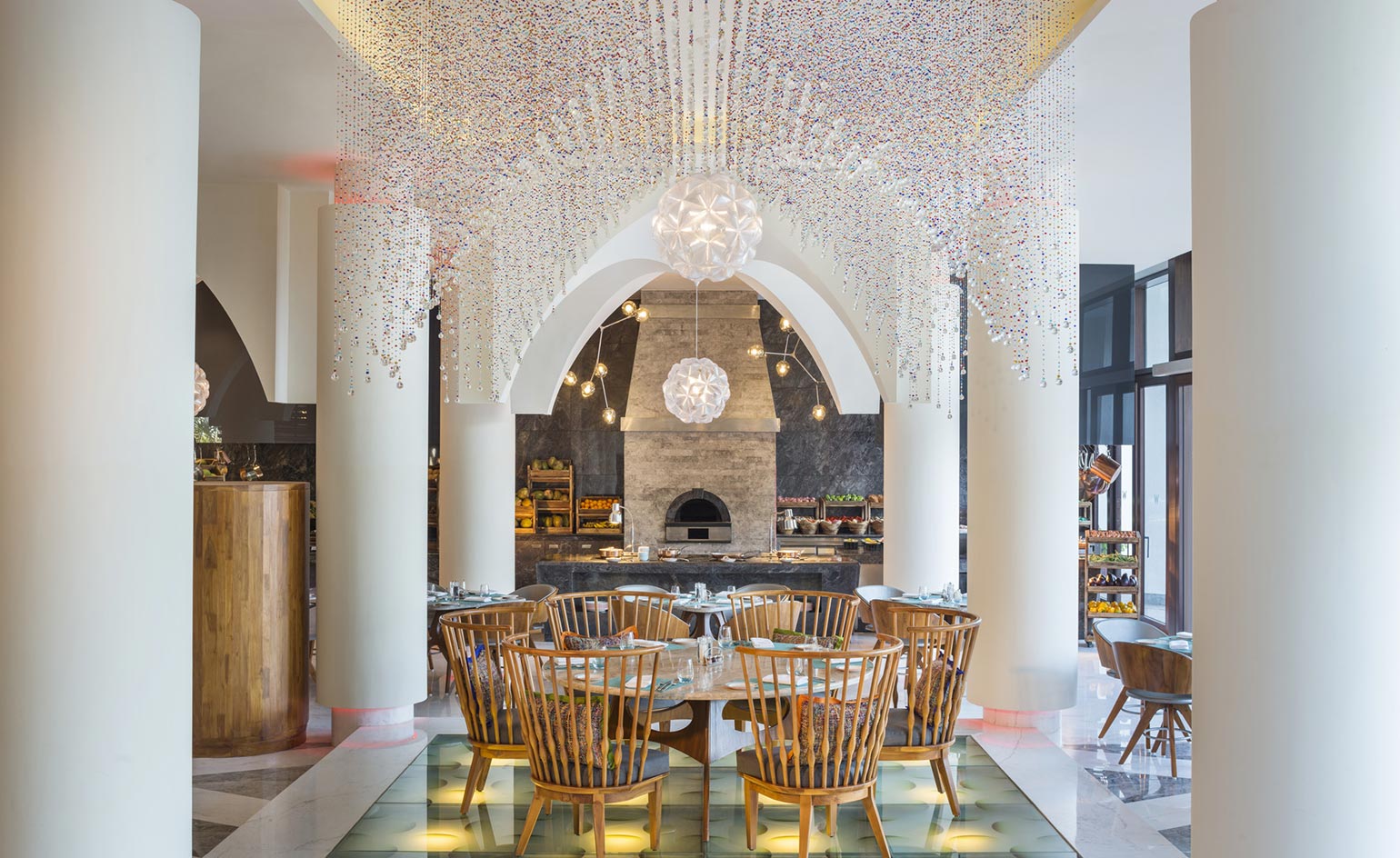 Wooden seating area with draping glass beads from ceiling