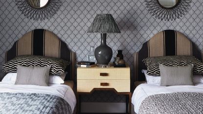 An example of sleep divorce in one bedroom - twin single beds, black and grey headboard
