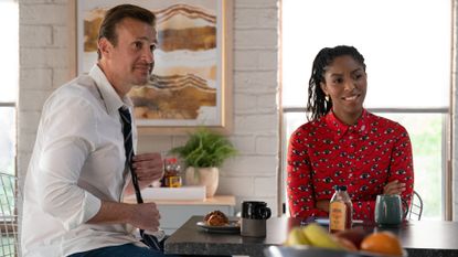 Jason Segel as Jimmy and Jessica Williams as Gaby, sitting at the counter in an office kitchen, in &#039;Shrinking&#039;