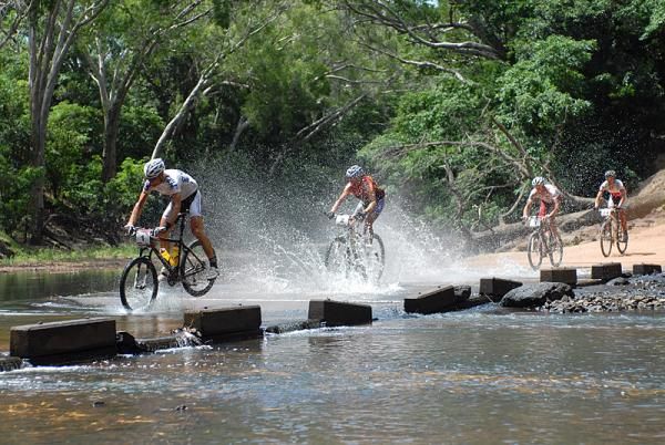 Urs Huber, Bart Brentjens and Mike Mulkens speed through a river