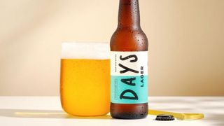 Days Brewing Lager in glass next o bottle