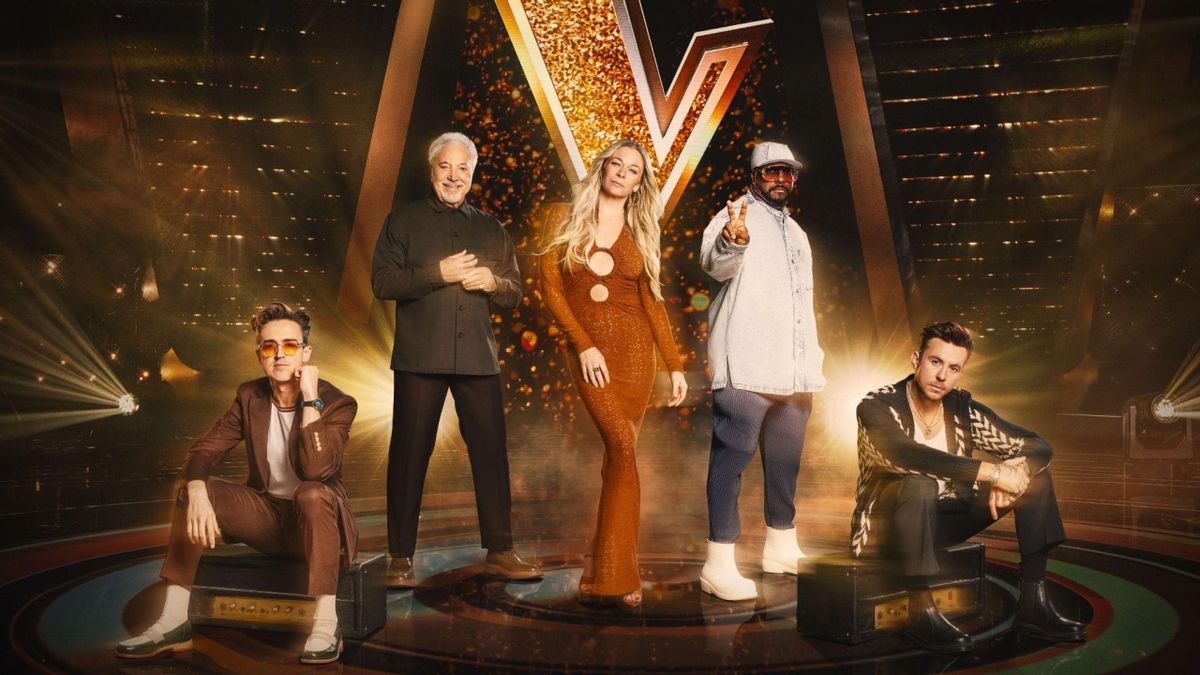 The 2024 The Voice UK judging line-up of (L-R) Tom Fletcher, Tom Jones, LeAnn Rimes, will.i.am and Danny Jones pose on the show&#039;s set in-front of a large &#039;V&#039; logo