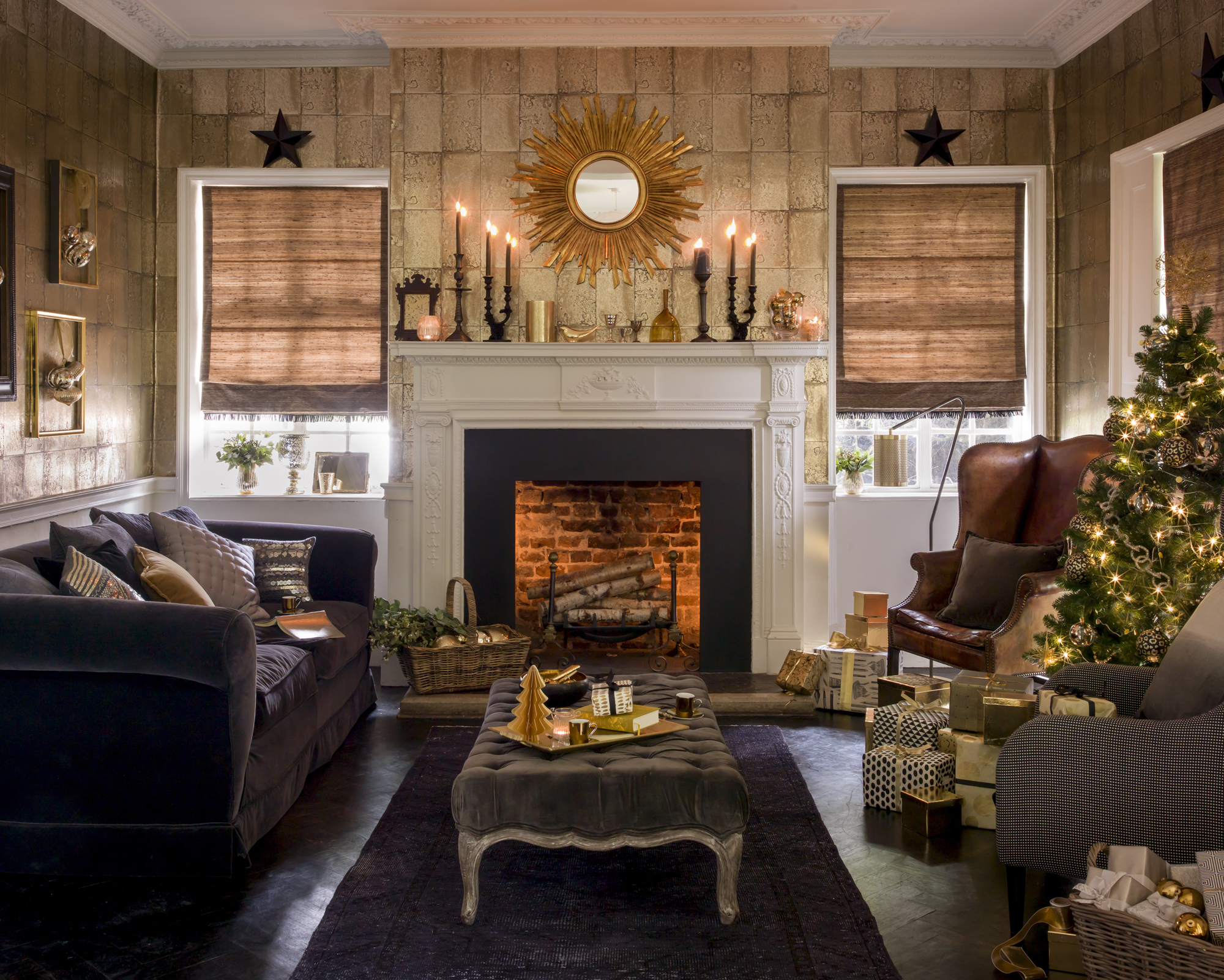 Christmas fireplace decor with gold candles, wallpaper and mirror