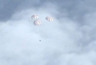 Orion Capsule with Three Main Chutes Deployed