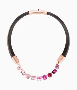 Pink stoned necklace with black loop around neck