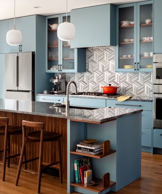 modern kitchen with blue cabinets, kitchen island and wood flooring