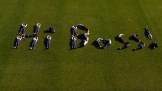 The team spelling Hi Boss with their bodies on the pitch.