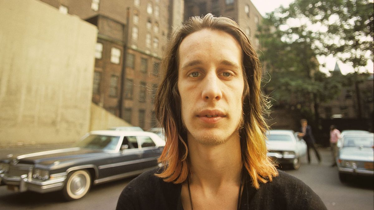 Todd Rundgren standing by an apartment block in New York July 1974