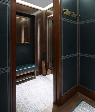 In the dressing rooms, leather panels in Kent & Curwen's signature field green incorporate white stitching