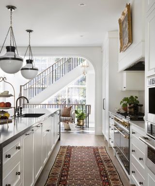 kitchen with white cabinets and vintage rug