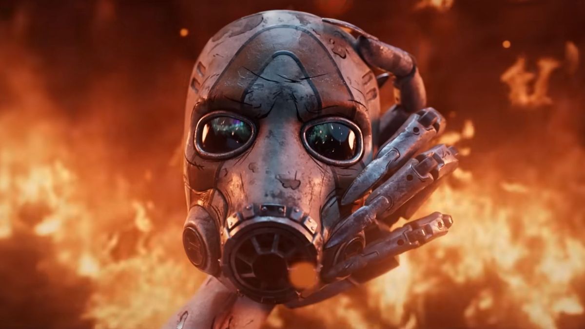 A cybernetic hand holds an iconic mask plucked from flames in this screenshot of the Borderlands 4 teaser trailer from Gamescom in August 2024.