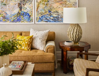 A living room with art on the walls and colorful decor