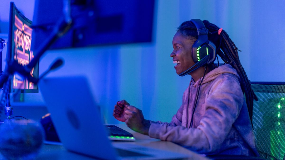 Premium Photo  Player feeling happy after winning video games on computer.  man celebrating online win and playing games with headphones and monitor.  gamer using gaming technology and equipment.