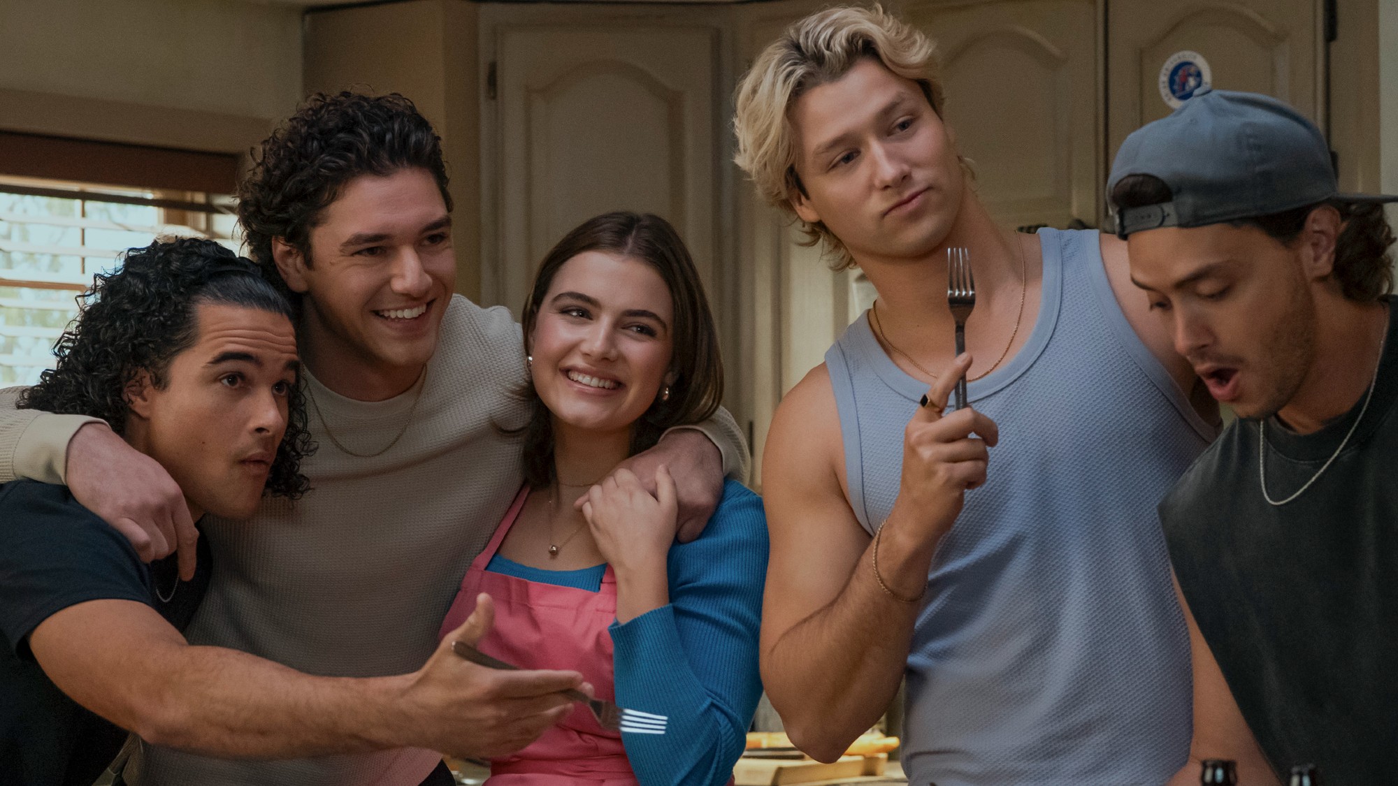 Tucker, Garrett, Hannah, Dean and Logan all standing around a table in Off Campus. 