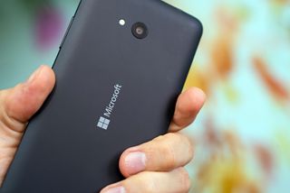 Windows 10 phone Lumia being held in the palm of a user's hand