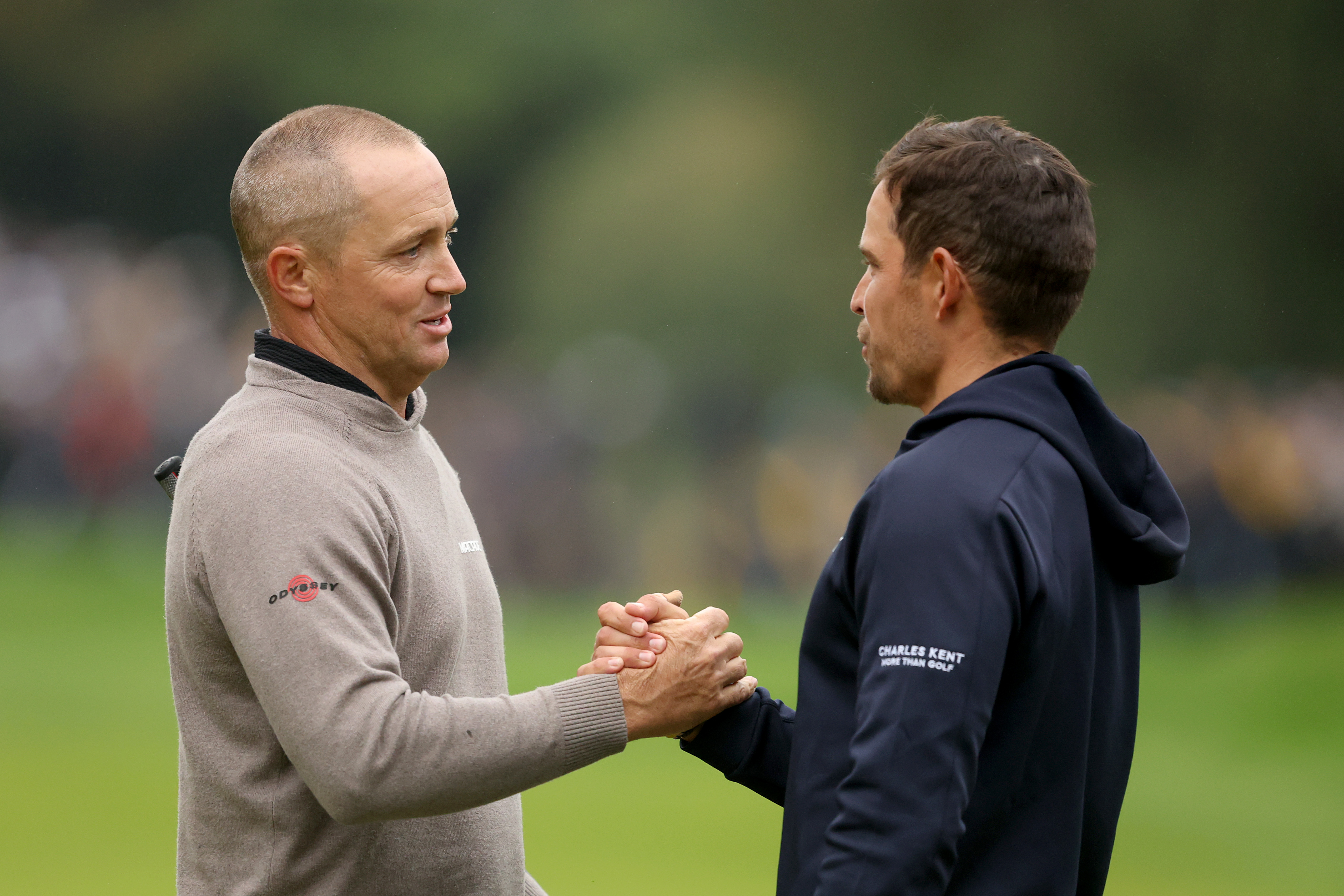 Alex Noren and Adrien Saddier shake hands on the 18th green
