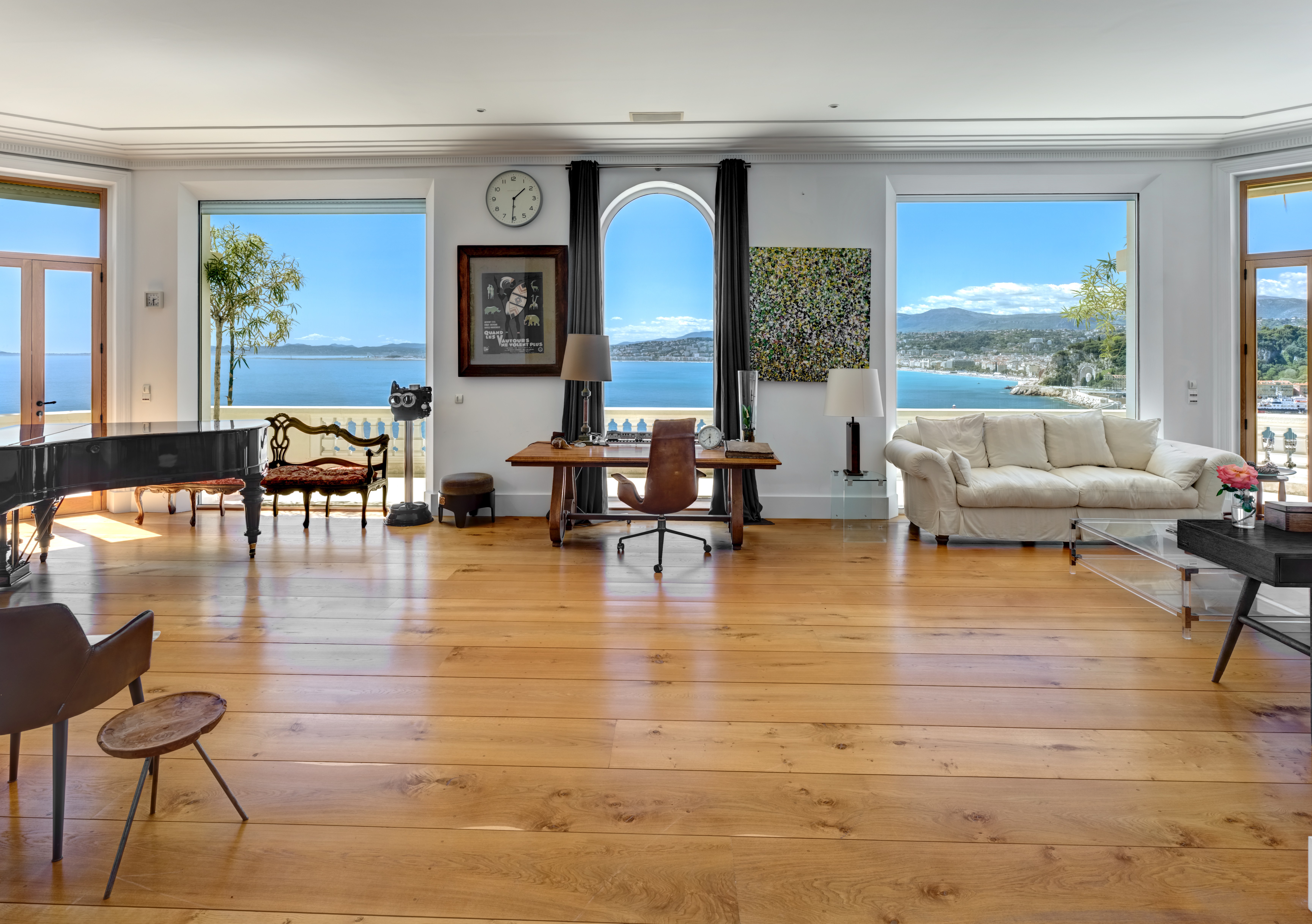 Inside Roc Fleuri, a large living room with sea views and a grand piano.