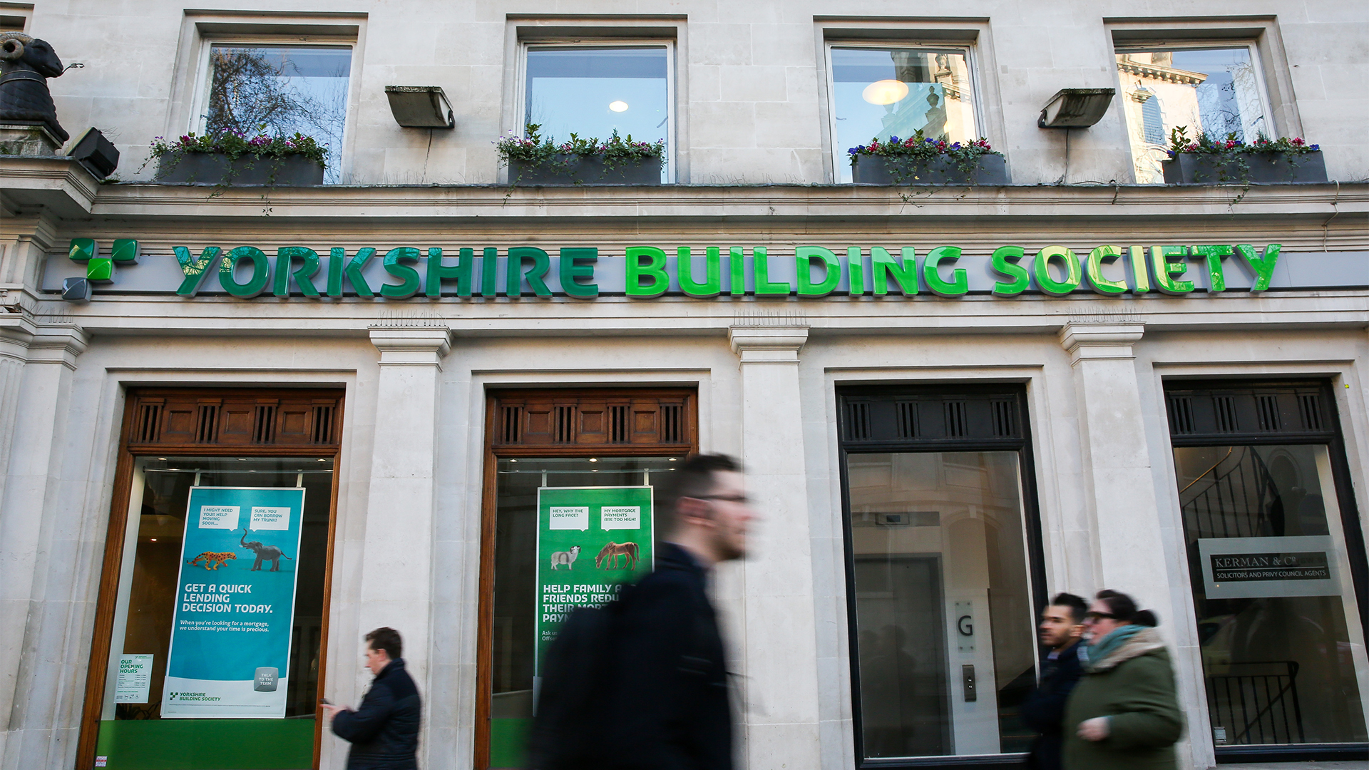 Yorkshire Building Society branch shopfront pictured in London, England, with pedestrians walking by in foreground.