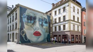 A hanging picture of a face wearing sunglasses 