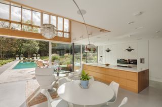 large kitchen diner with various types of lighting and view to garden