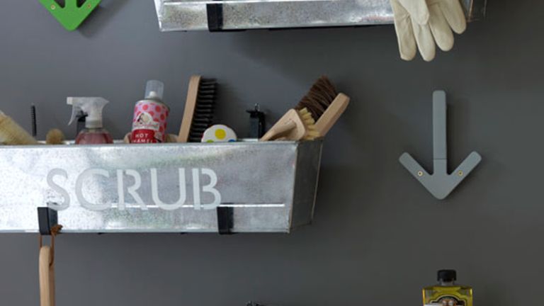 laundry room with grey walls and washing accessories in baskets