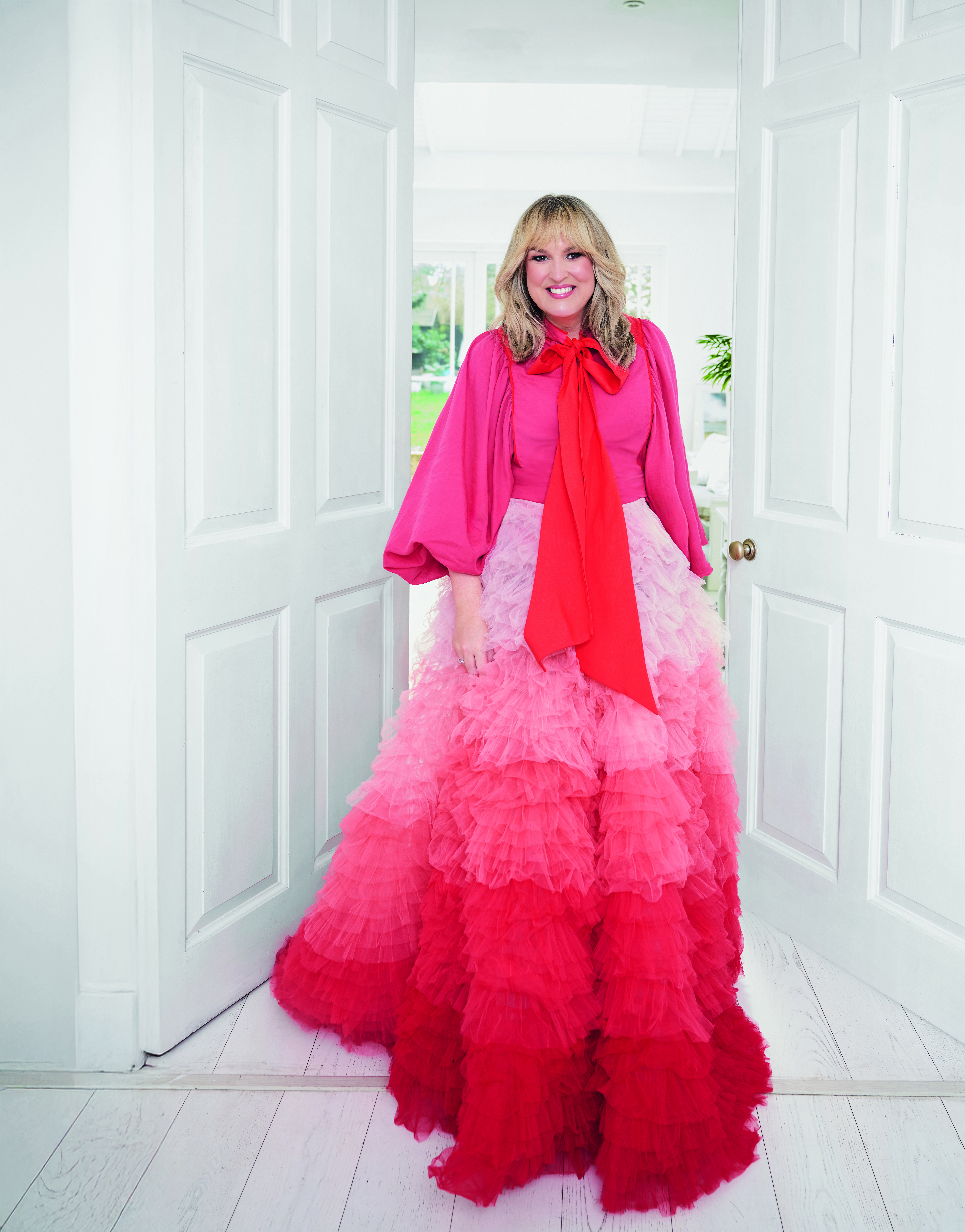 Sara Davies in a red ombre dress with ruffles