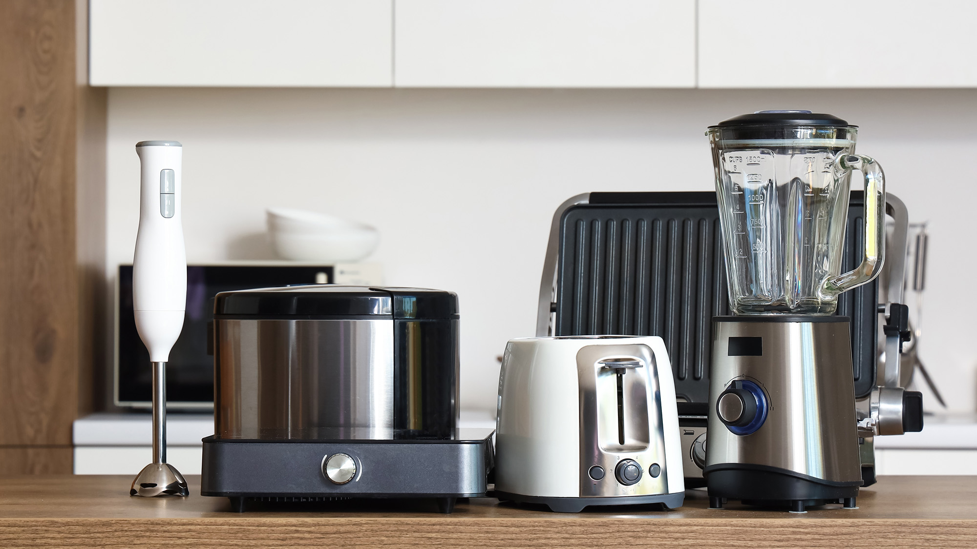 Set of modern appliances on wooden table in contemporary kitchen
