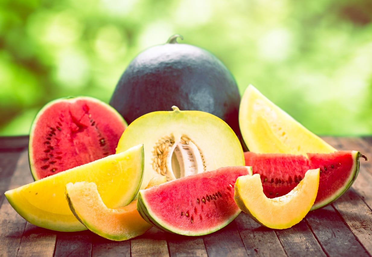 Several Different Melons Sliced On A Table