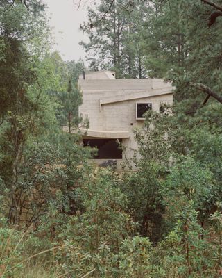 hero exterior of brutalist casa alferez in the woods