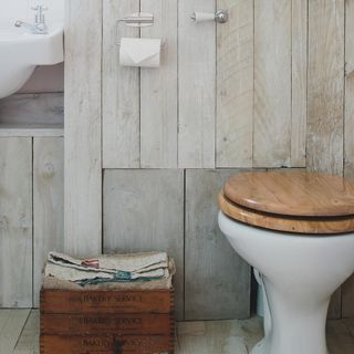 bathroom with wooden flooring and wooden walls