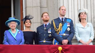 ueen Elizabeth II, Meghan, Duchess of Sussex, Prince Harry, Duke of Sussex, The Prince and Princess of Wales William and Catherine watch the RAF 100th anniversary flypast from the balcony of Buckingham Palace on July 10, 2018 in London, England