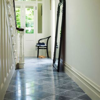 hallway with diamond tiles and mirror