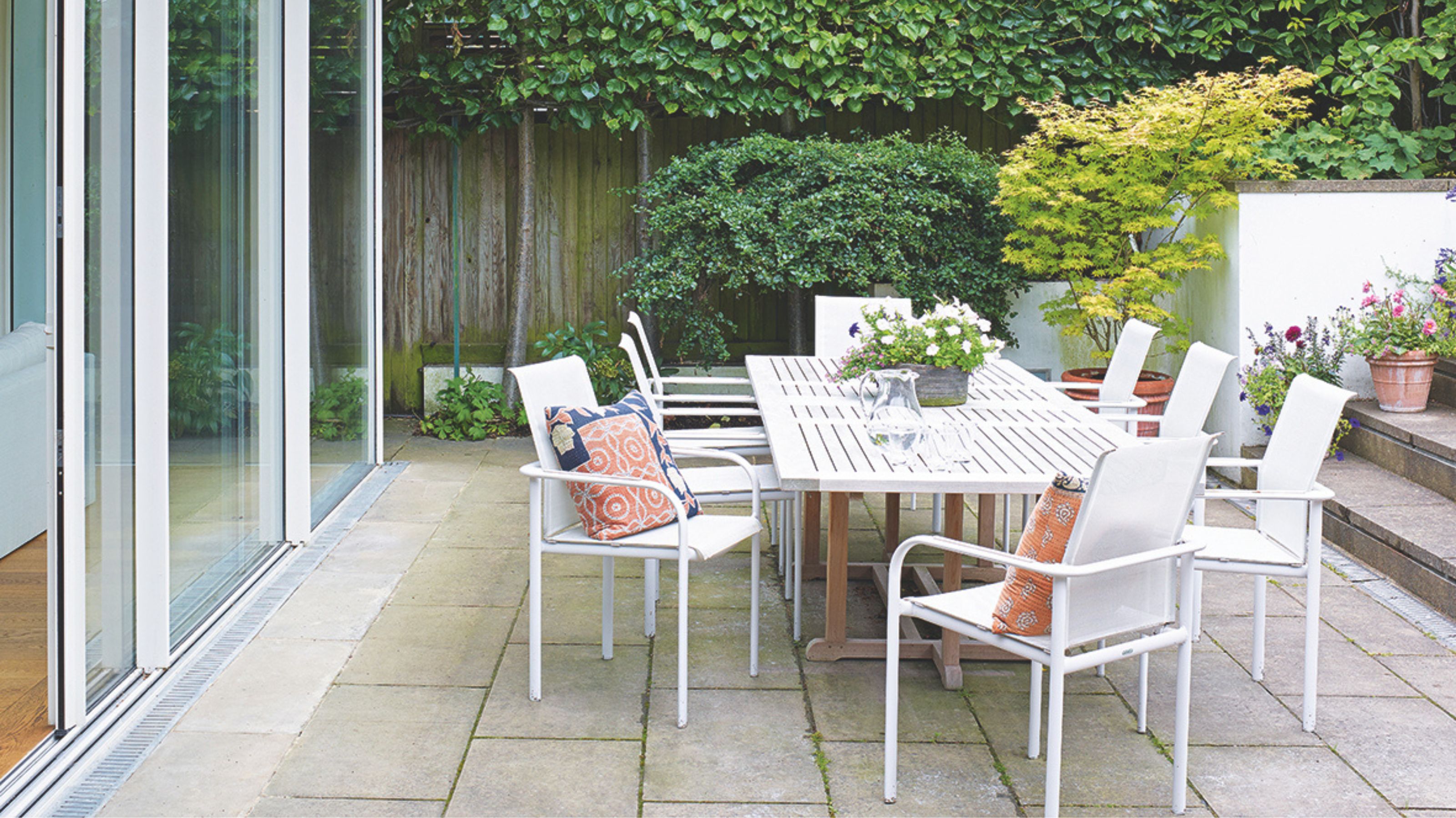 Paved patio with white table and chairs