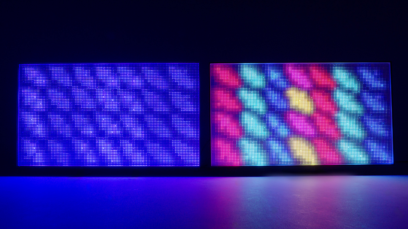 The exposed backlights of two TVs running side by side. On the left, the image is purely white/blue. On the right, there's full colour and a clearer pattern.