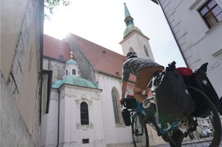 Image shows Stefan riding towards St Martin's Cathedral in Bratislava, Slovakia