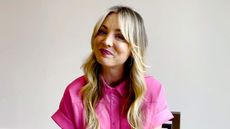 kaley cuoco on a white background wearing pink